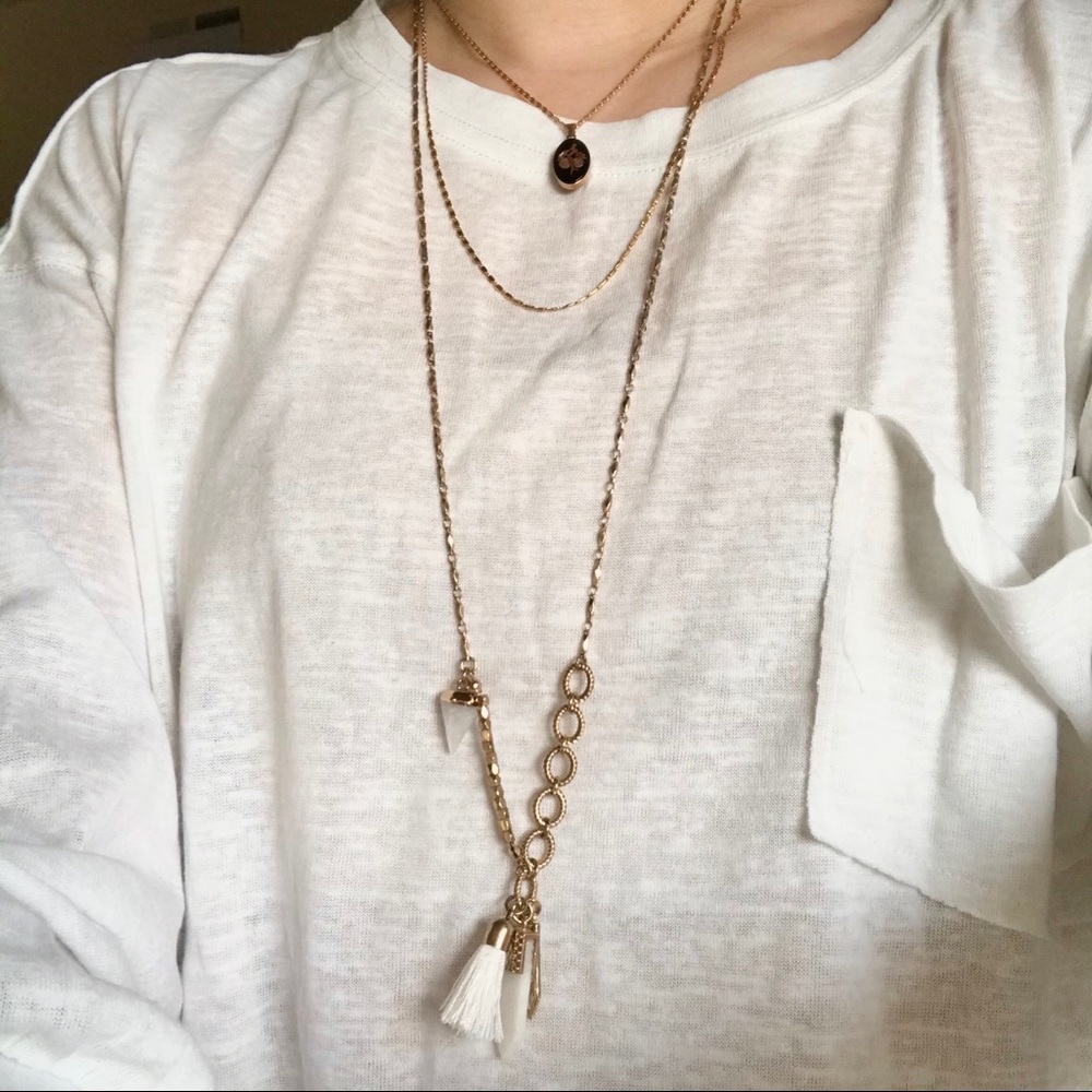 Gold tone charm white necklace